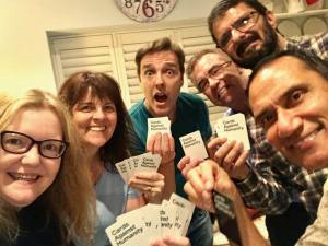 six people playing scrabble